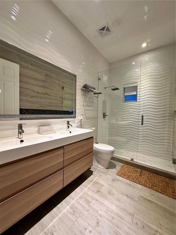 Bathroom, Dual Sink Vanities, Glass Shower, Interior, Recessed Lighting, Wood Texture Flooring
