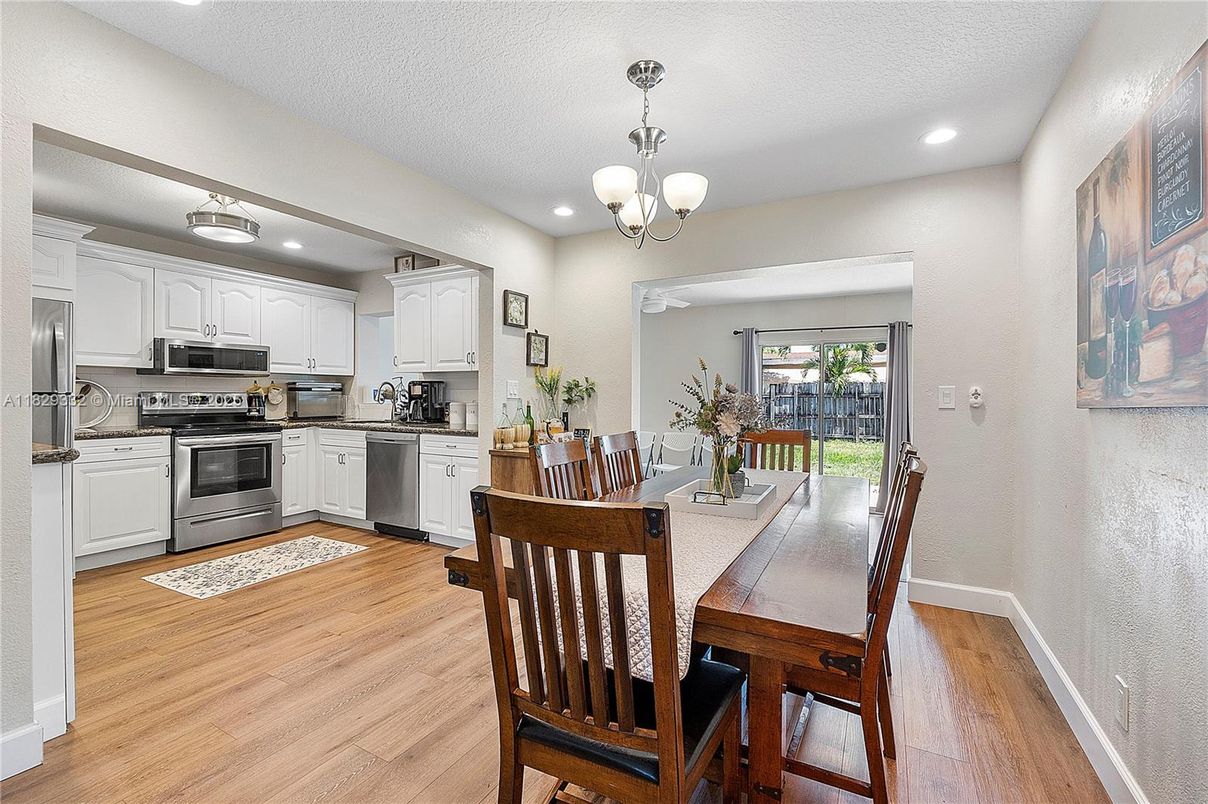 Chandelier, Dining room, Interior, Kitchen, Pendant Lights, Recessed Lighting, Stainless Steel Appliances, Wood Texture Flooring