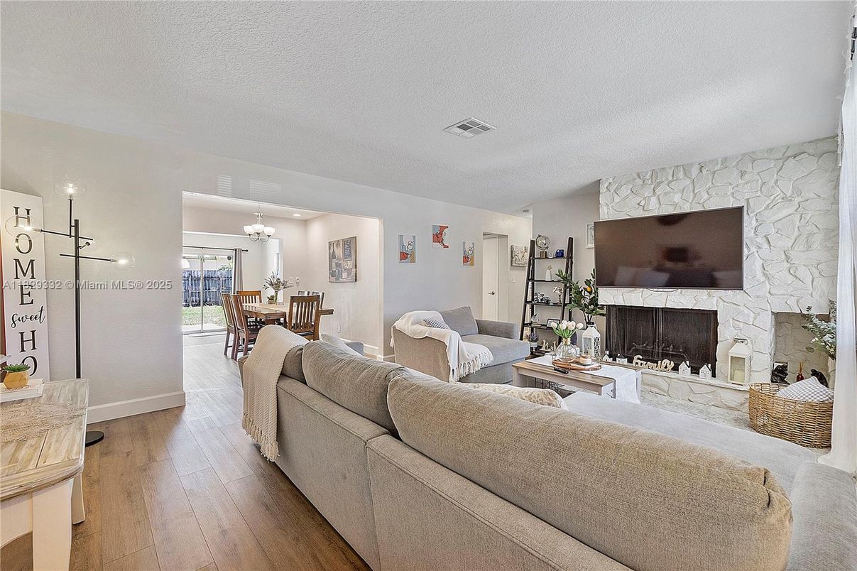 Chandelier, Dining room, Fireplace, Interior, Living room, Stone Walls, Wood Texture Flooring