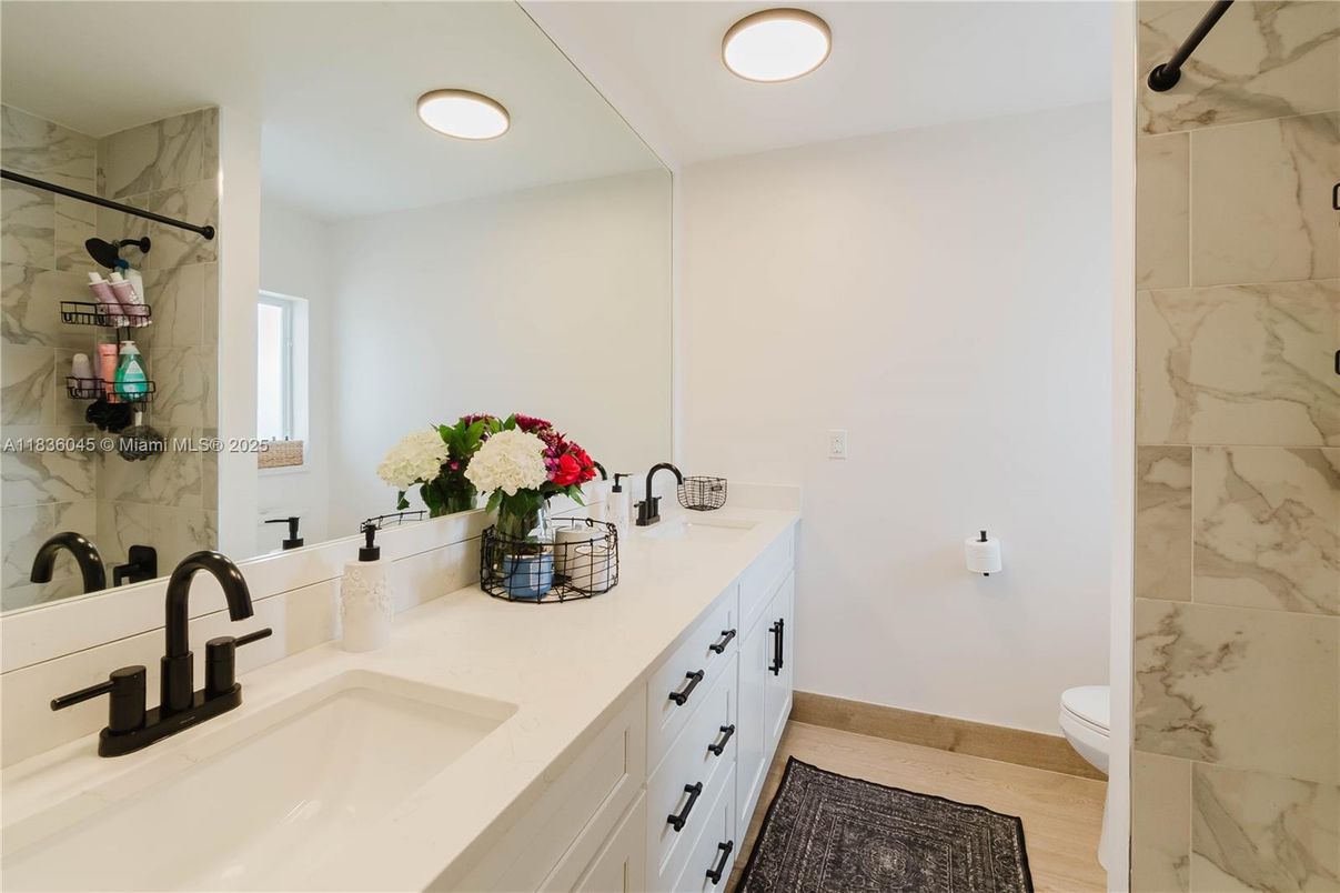 Bathroom, Dual Sink Vanities, Interior, Marble Walls, Recessed Lighting, Wood Texture Flooring