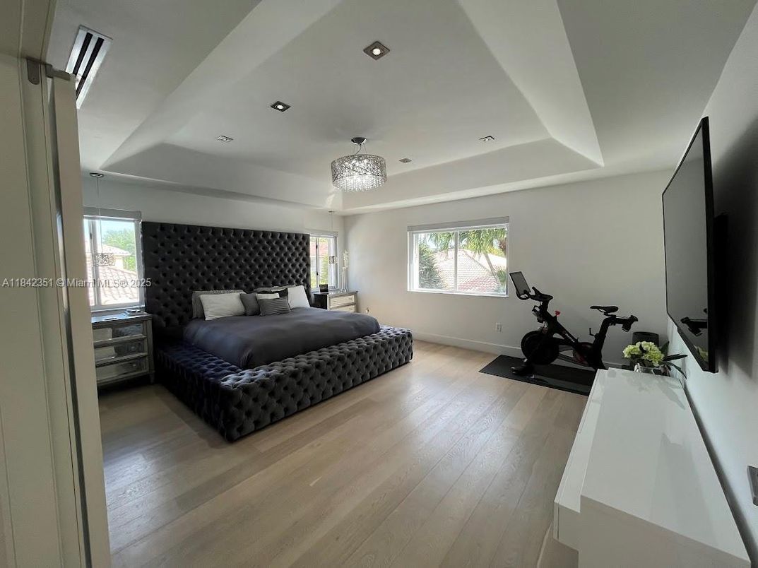 Bedroom, Chandelier, Fitness Equipment, Interior, Recessed Lighting, Wood Texture Flooring