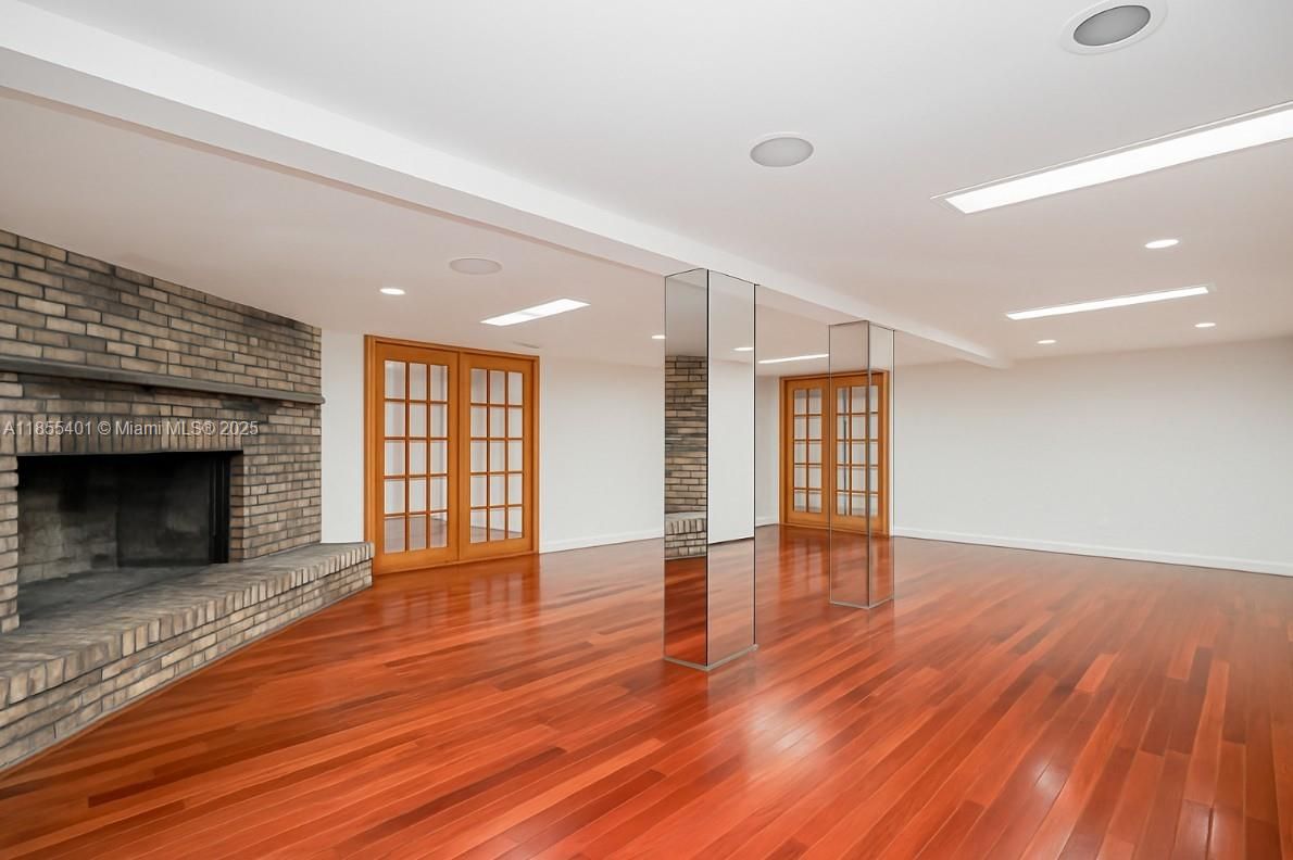 Empty room, Fireplace, Interior, Recessed Lighting, Stone Walls, Wood Texture Flooring