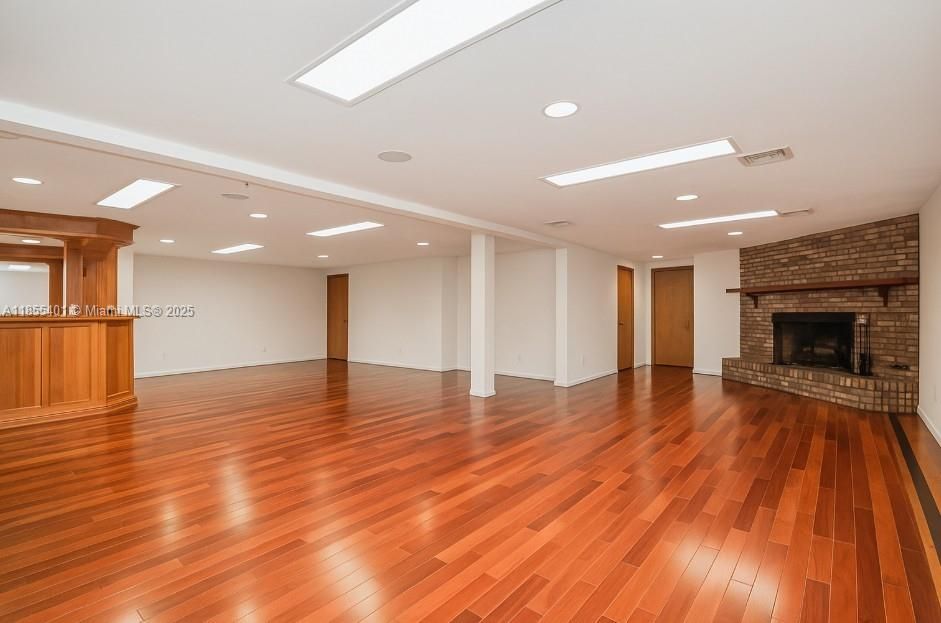 Empty room, Fireplace, Interior, Recessed Lighting, Stone Walls, Wood Texture Flooring