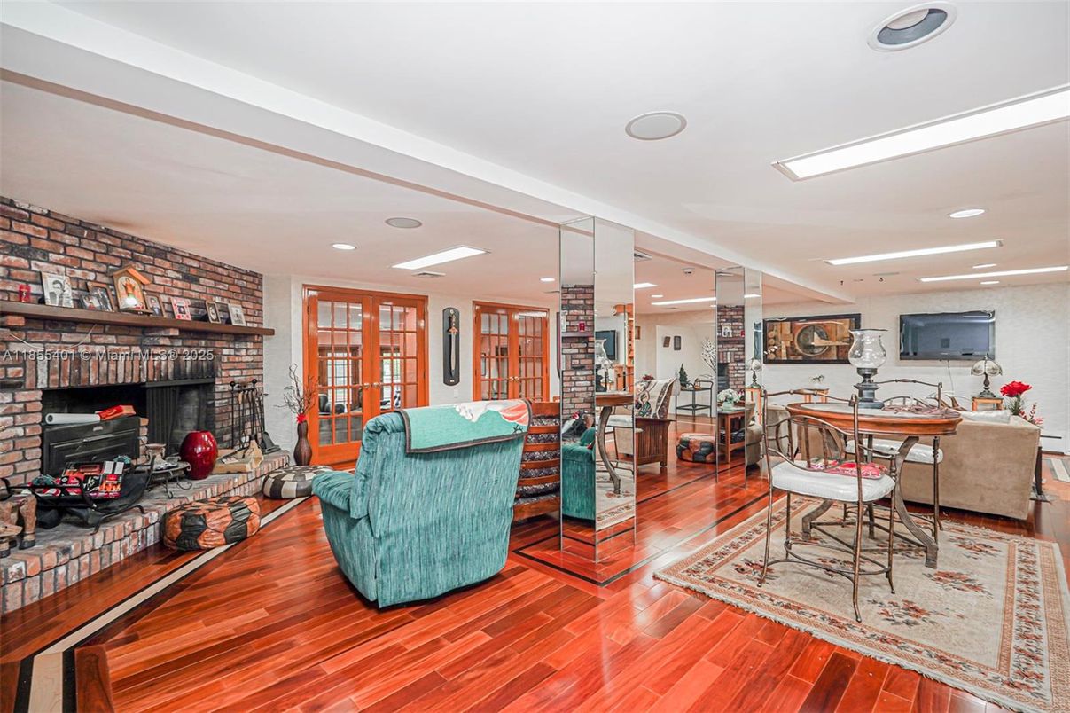 Dining room, Fireplace, Interior, Living room, Recessed Lighting, Stone Walls, Wood Texture Flooring