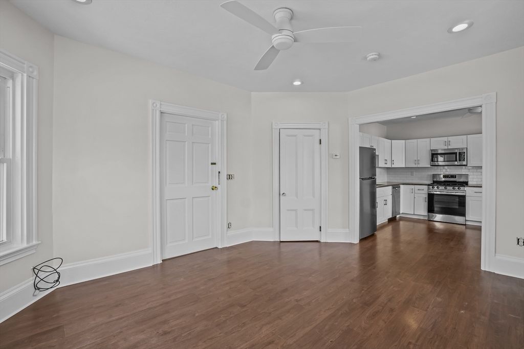 Empty room, Interior, Kitchen, Recessed Lighting, Stainless Steel Appliances, Wood Texture Flooring