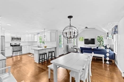 Chandelier, Dining room, Interior, Kitchen, Living room, Pendant Lights, Recessed Lighting, Stainless Steel Appliances, Wood Texture Flooring