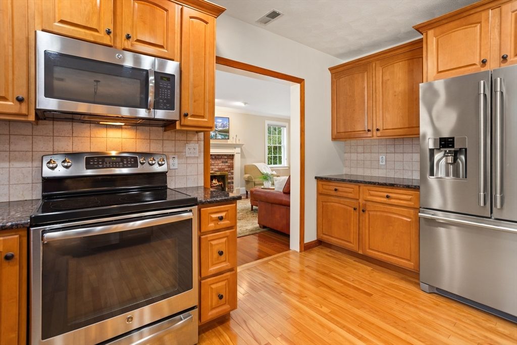 Fireplace, Interior, Kitchen, Living room, Recessed Lighting, Stainless Steel Appliances, Wood Texture Flooring