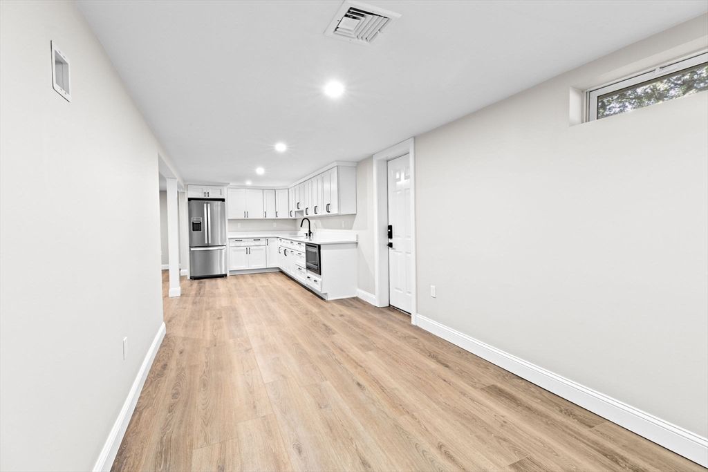 Empty room, Interior, Kitchen, Recessed Lighting, Stainless Steel Appliances, Wood Texture Flooring