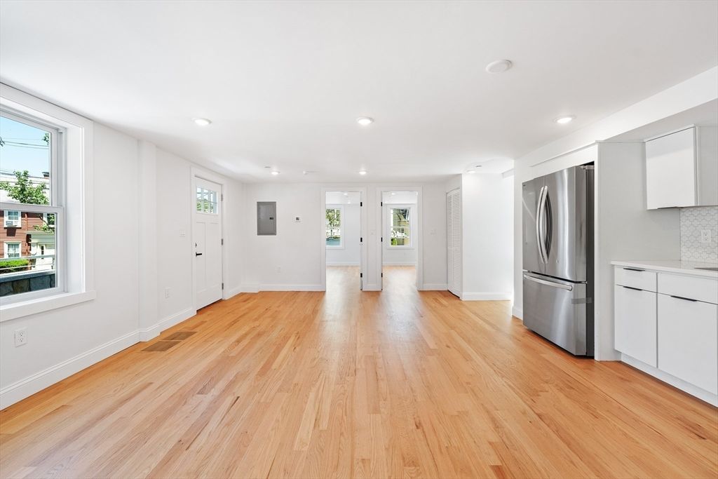 Empty room, Interior, Kitchen, Recessed Lighting, Stainless Steel Appliances, Wood Texture Flooring