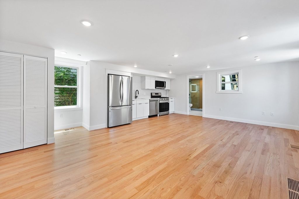 Empty room, Interior, Kitchen, Recessed Lighting, Stainless Steel Appliances, Wood Texture Flooring