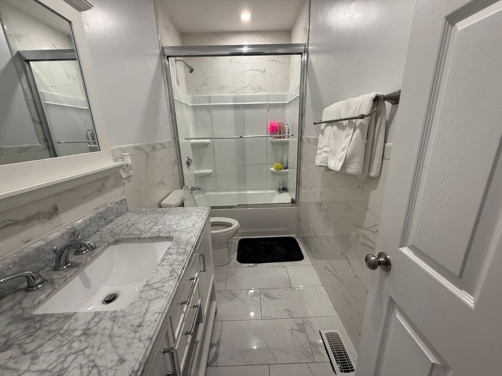 Bathroom, Dual Sink Vanities, Glass Shower, Interior, Marble, Marble Walls, Recessed Lighting