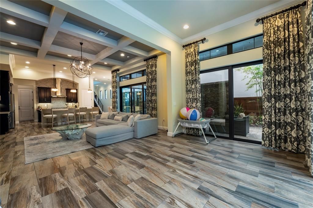 Chandelier, Interior, Kitchen, Living room, Pendant Lights, Recessed Lighting, Stainless Steel Appliances, Wood Texture Flooring