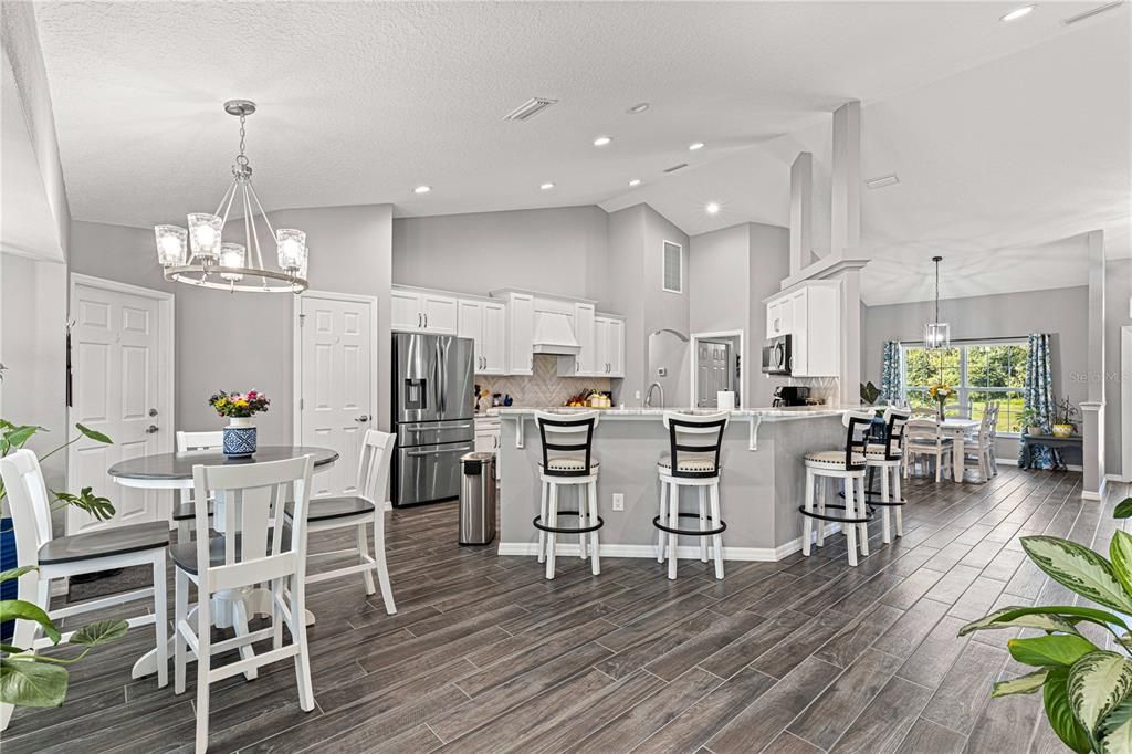 Chandelier, Dining room, Interior, Kitchen, Pendant Lights, Recessed Lighting, Stainless Steel Appliances, Wood Texture Flooring