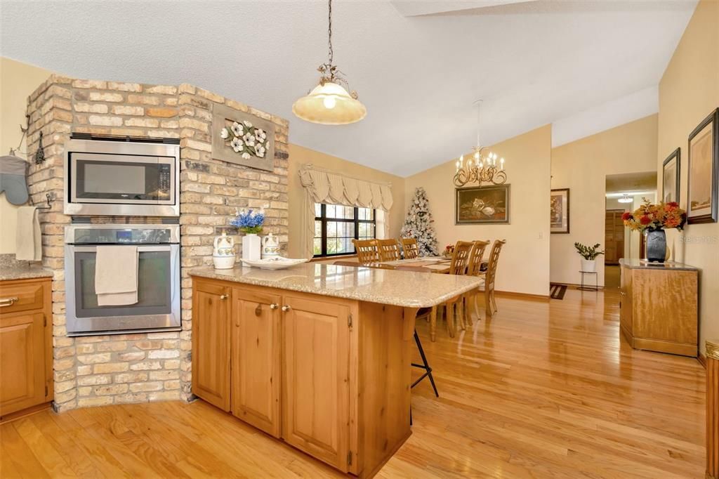 Chandelier, Dining room, Fireplace, Interior, Pendant Lights, Stone Walls, Wood Texture Flooring