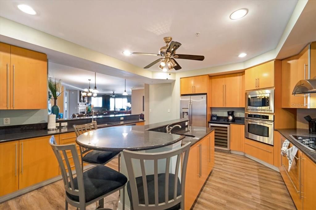Chandelier, Dining room, Interior, Kitchen, Pendant Lights, Recessed Lighting, Stainless Steel Appliances, Wood Texture Flooring