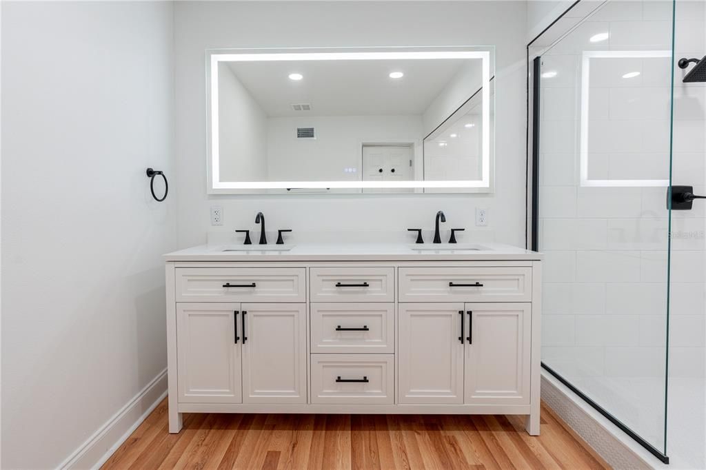 Bathroom, Dual Sink Vanities, Glass Shower, Interior, Recessed Lighting, Wood Texture Flooring