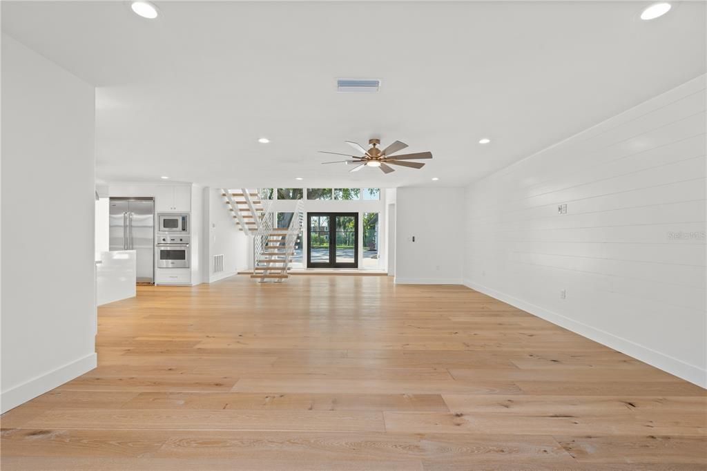 Empty room, Interior, Kitchen, Recessed Lighting, Stainless Steel Appliances, Wood Texture Flooring