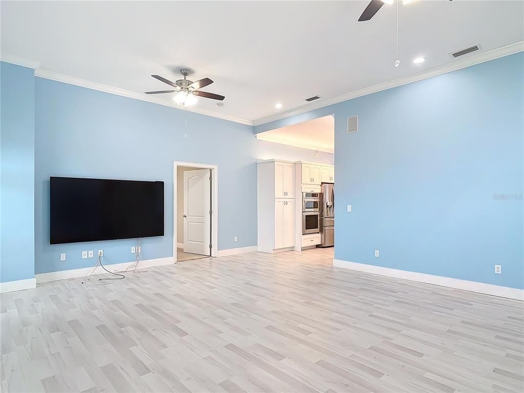 Empty room, Interior, Kitchen, Recessed Lighting, Stainless Steel Appliances, Wood Texture Flooring