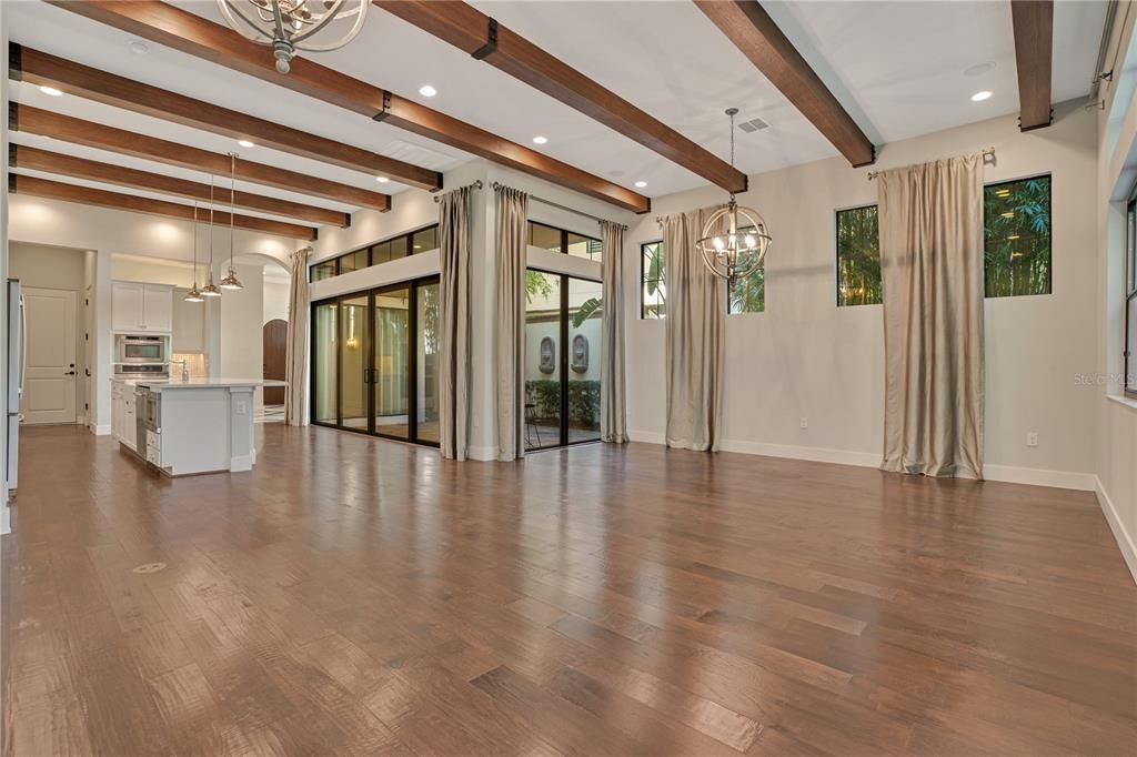 Empty room, Interior, Kitchen, Pendant Lights, Recessed Lighting, Stainless Steel Appliances, Wooden Beams, Wood Texture Flooring