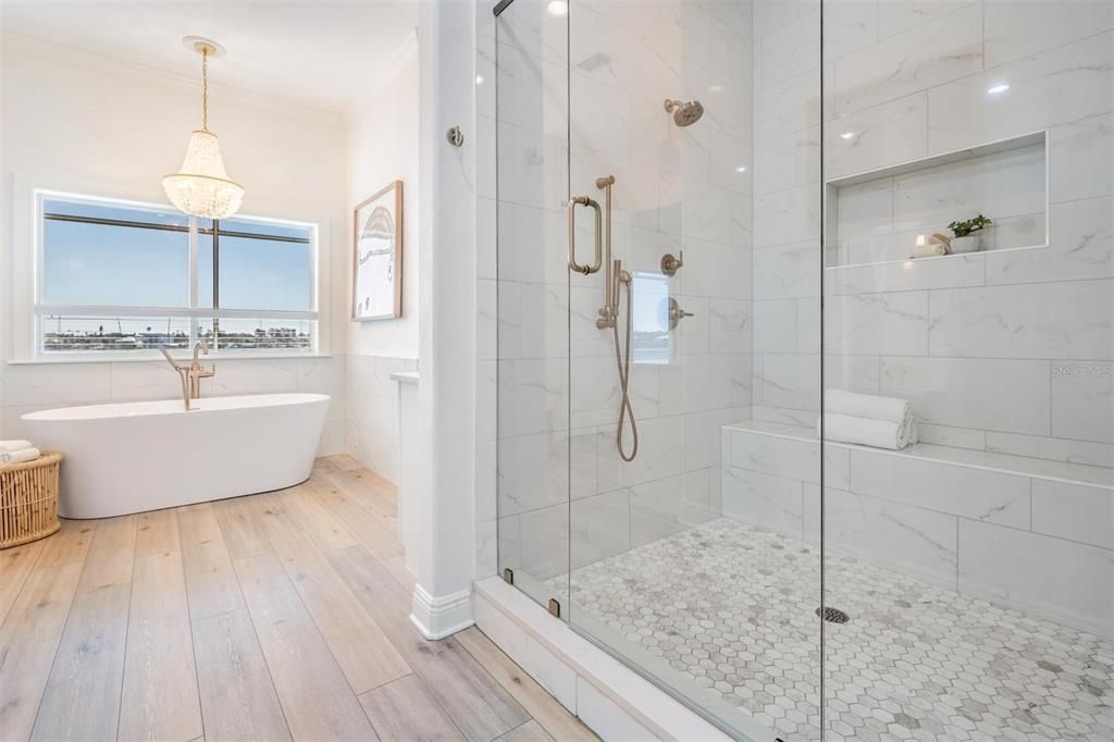 Bathroom, Free Standing Baths, Glass Shower, Interior, Marble Walls, Pendant Lights, Recessed Lighting, Wood Texture Flooring