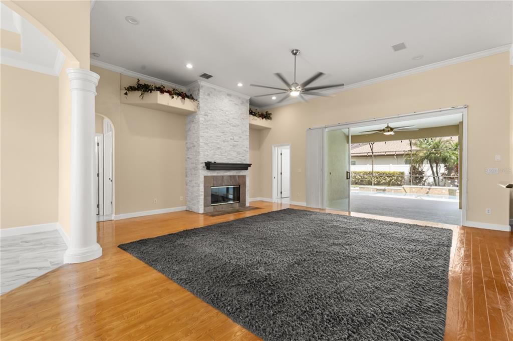 Empty room, Fireplace, Interior, Recessed Lighting, Stone Walls, Wood Texture Flooring