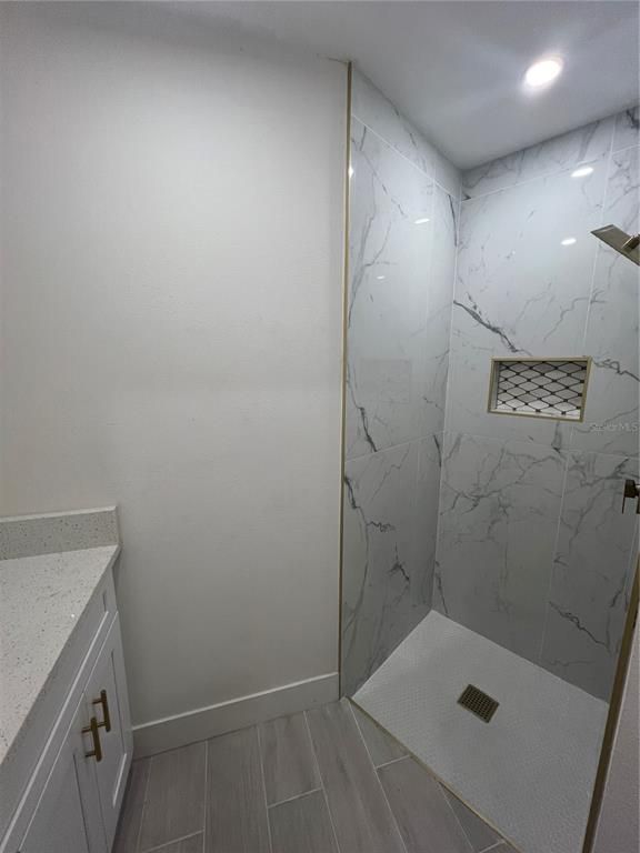 Bathroom, Glass Shower, Interior, Marble Walls, Recessed Lighting, Wood Texture Flooring