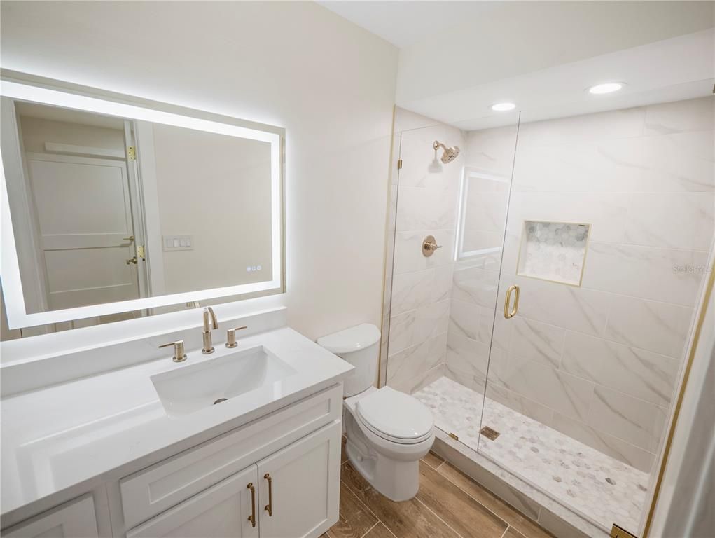 Bathroom, Glass Shower, Interior, Marble Walls, Recessed Lighting, Wood Texture Flooring