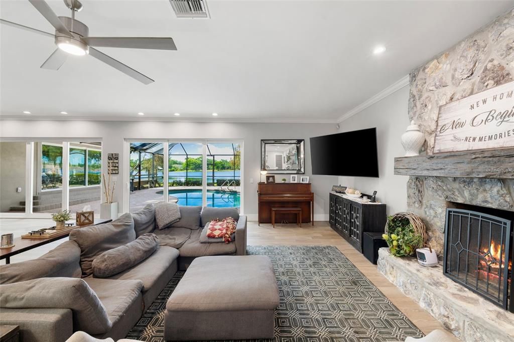 Fireplace, Interior, Living room, Piano, Recessed Lighting, Stone Walls, Wood Texture Flooring