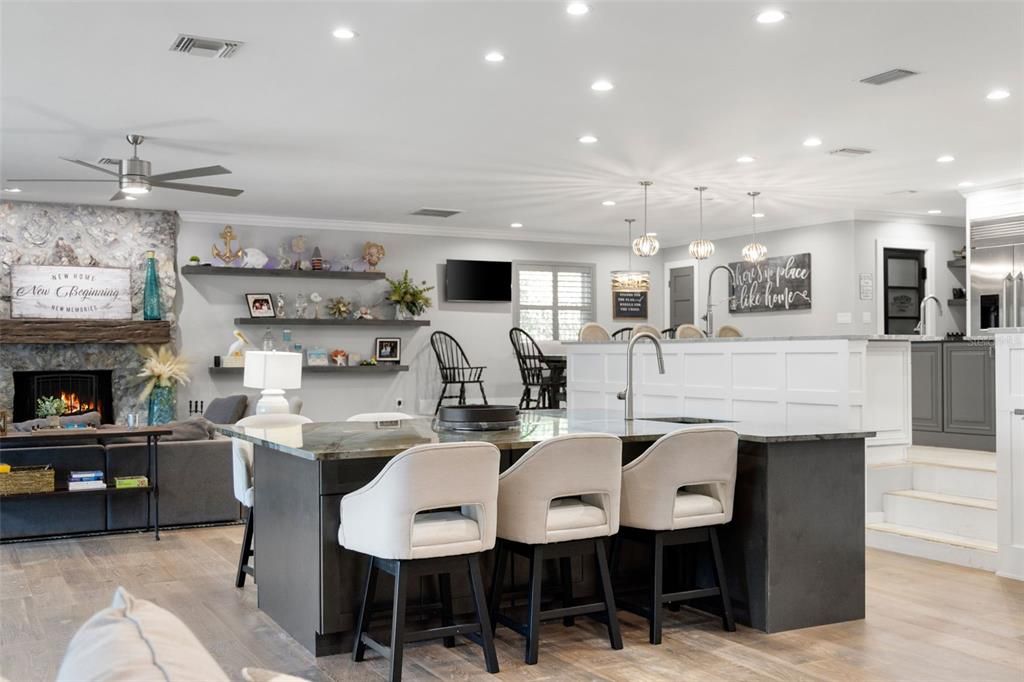 Fireplace, Interior, Kitchen, Living room, Pendant Lights, Recessed Lighting, Stainless Steel Appliances, Wood Texture Flooring