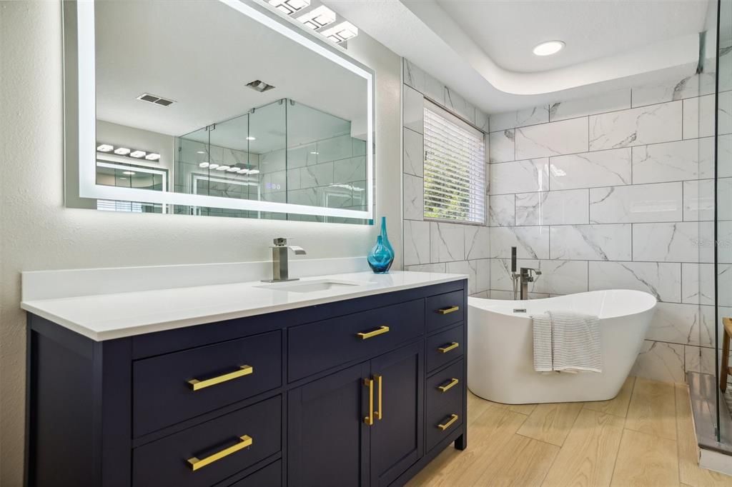 Bathroom, Dual Sink Vanities, Free Standing Baths, Glass Shower, Interior, Marble Walls, Recessed Lighting, Wood Texture Flooring