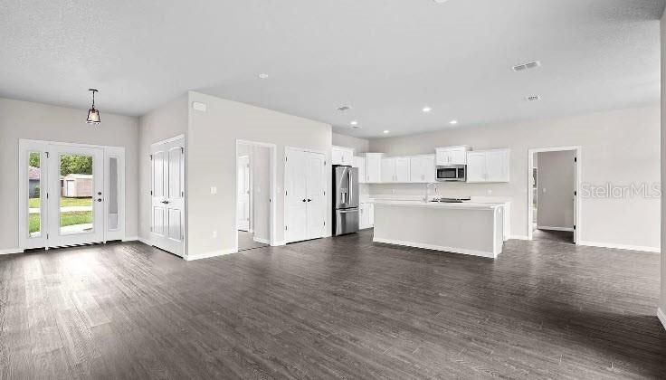 Empty room, Interior, Kitchen, Pendant Lights, Recessed Lighting, Stainless Steel Appliances, Wood Texture Flooring