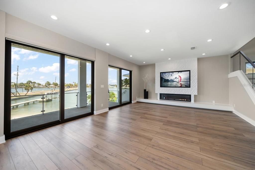 Empty room, Fireplace, Interior, Recessed Lighting, Water, Wood Texture Flooring