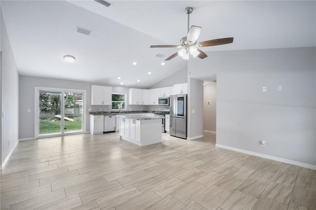 Empty room, Interior, Kitchen, Recessed Lighting, Stainless Steel Appliances, Wood Texture Flooring