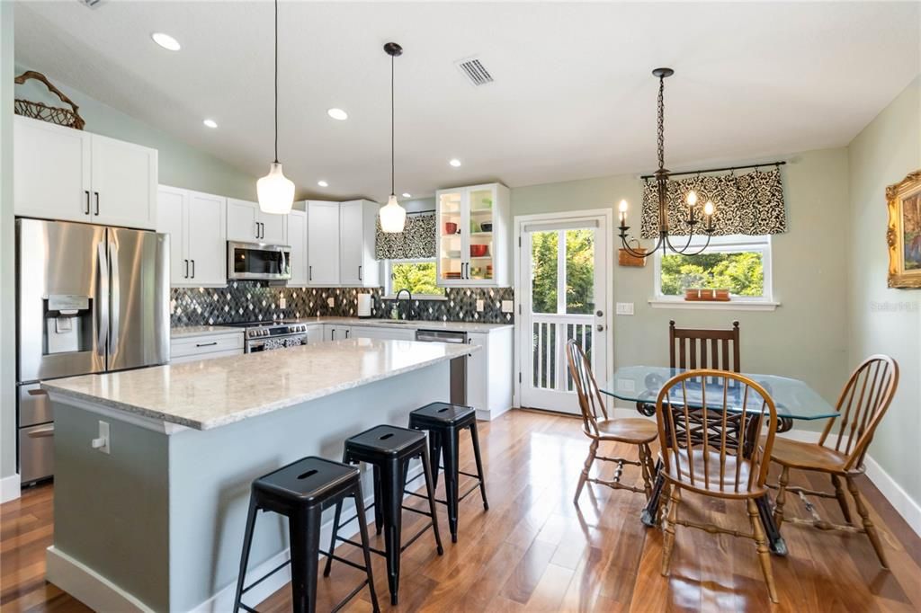 Dining room, Interior, Kitchen, Pendant Lights, Recessed Lighting, Stainless Steel Appliances, Wood Texture Flooring