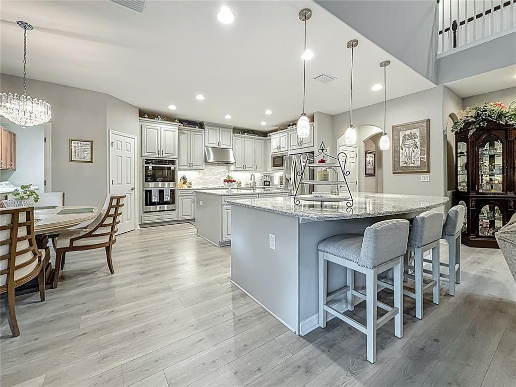 Chandelier, Dining room, Interior, Kitchen, Pendant Lights, Recessed Lighting, Stainless Steel Appliances, Wood Texture Flooring