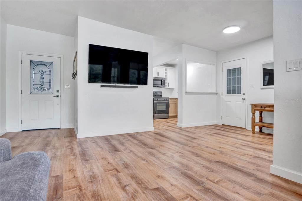 Empty room, Interior, Kitchen, Recessed Lighting, Stainless Steel Appliances, Wood Texture Flooring