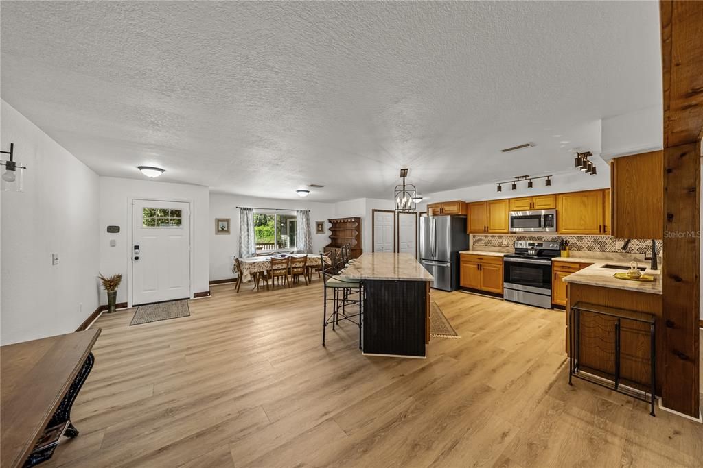 Chandelier, Dining room, Interior, Kitchen, Pendant Lights, Stainless Steel Appliances, Wood Texture Flooring