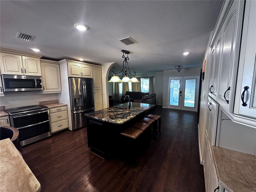 Chandelier, Interior, Kitchen, Pendant Lights, Recessed Lighting, Stainless Steel Appliances, Wood Texture Flooring