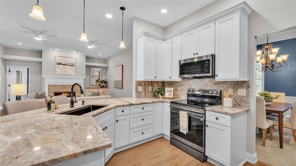 Dining room, Fireplace, Interior, Kitchen, Pendant Lights, Recessed Lighting, Stainless Steel Appliances, Wood Texture Flooring