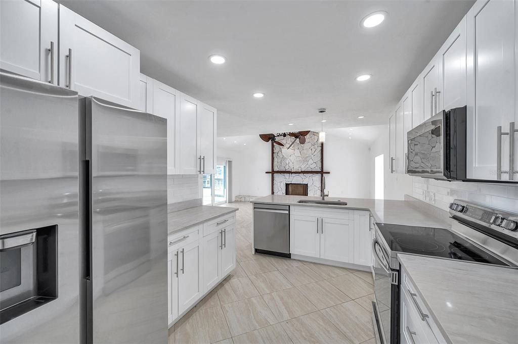 Interior, Kitchen, Pendant Lights, Recessed Lighting, Stainless Steel Appliances, Stone Walls