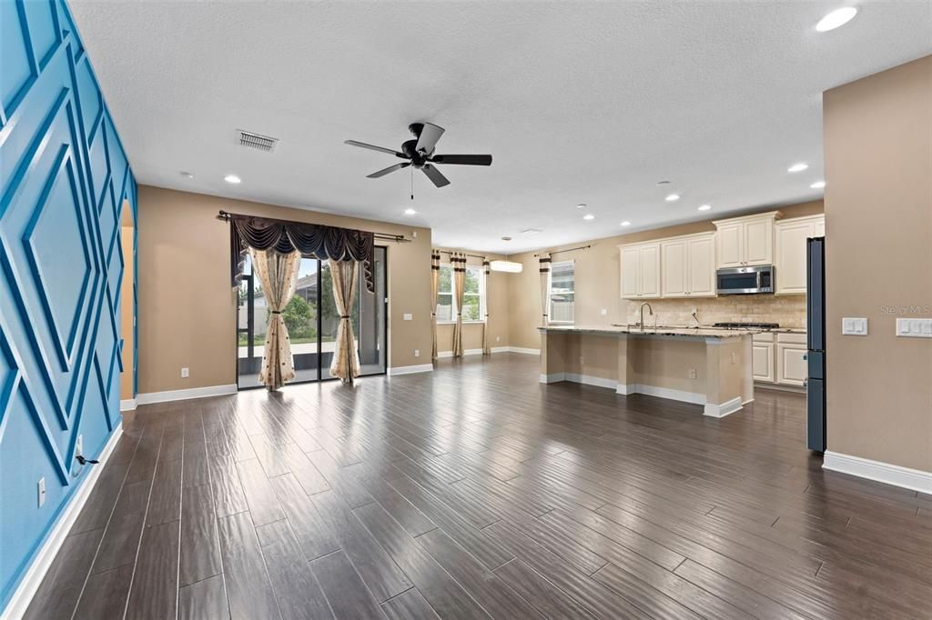 Empty room, Interior, Kitchen, Recessed Lighting, Stainless Steel Appliances, Wood Texture Flooring