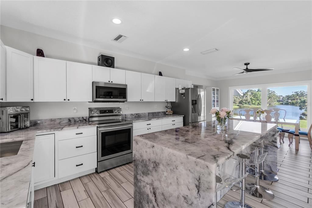 Dining room, Interior, Kitchen, Recessed Lighting, Stainless Steel Appliances, Water, Wood Texture Flooring