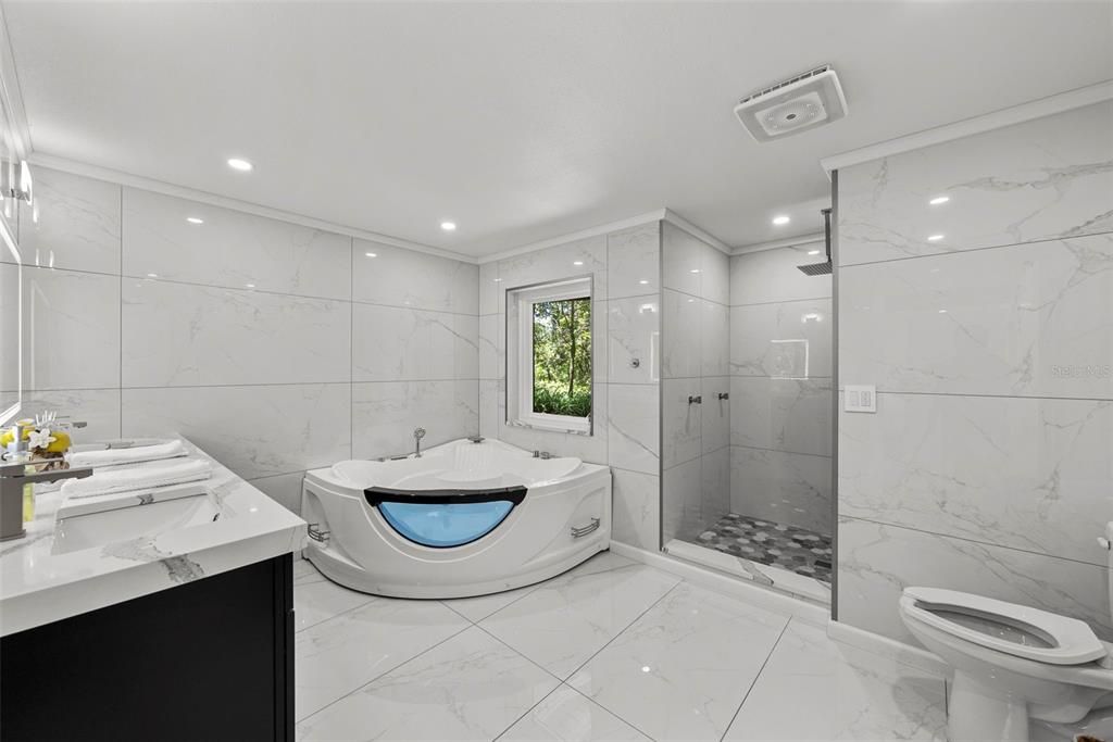 Bathroom, Dual Sink Vanities, Glass Shower, Interior, Marble, Marble Walls, Recessed Lighting