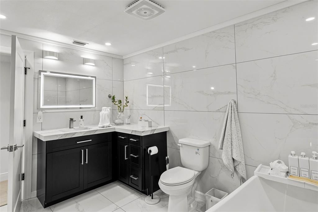 Bathroom, Dual Sink Vanities, Glass Shower, Interior, Marble, Marble Walls, Recessed Lighting