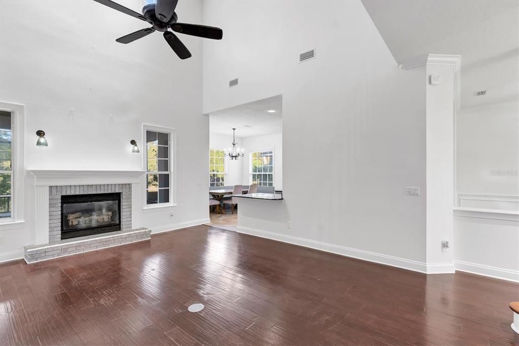 Chandelier, Dining room, Empty room, Fireplace, Interior, Recessed Lighting, Wood Texture Flooring