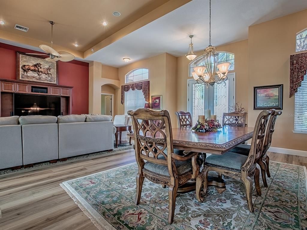 Chandelier, Dining room, Fireplace, Interior, Living room, Pendant Lights, Recessed Lighting, Wood Texture Flooring