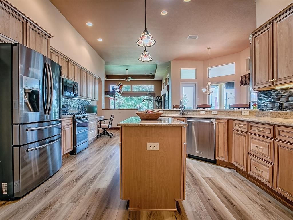 Dining room, Interior, Kitchen, Pendant Lights, Recessed Lighting, Stainless Steel Appliances, Wood Texture Flooring