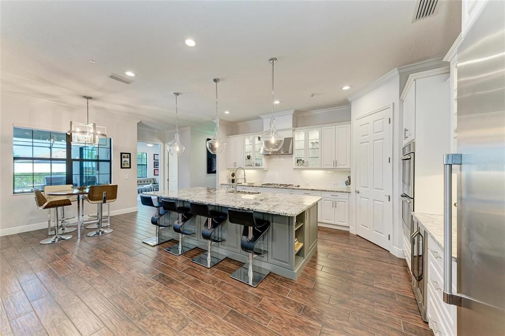 Dining room, Interior, Kitchen, Pendant Lights, Recessed Lighting, Stainless Steel Appliances, Wood Texture Flooring