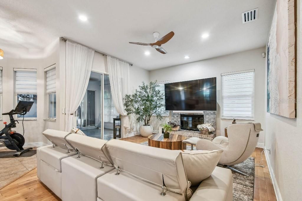 Fireplace, Fitness Equipment, Interior, Living room, Recessed Lighting, Wood Texture Flooring