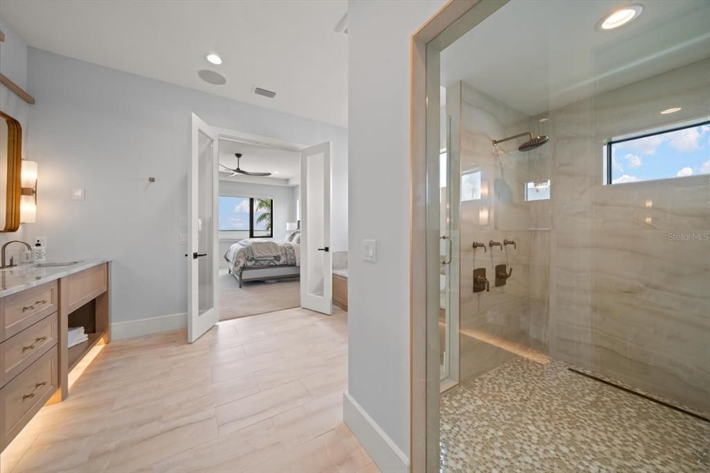 Bathroom, Bedroom, Dual Sink Vanities, Glass Shower, Interior, Marble Walls, Recessed Lighting, Wood Texture Flooring